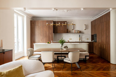 Exemple d'une salle à manger ouverte sur le salon tendance de taille moyenne avec un mur beige, parquet foncé et éclairage.