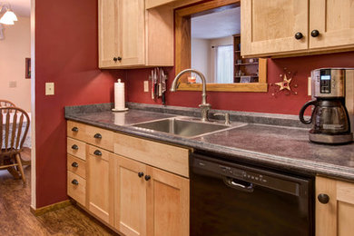 Enclosed kitchen - mid-sized traditional galley medium tone wood floor enclosed kitchen idea in Other with a drop-in sink, shaker cabinets, light wood cabinets, laminate countertops, stainless steel appliances and no island