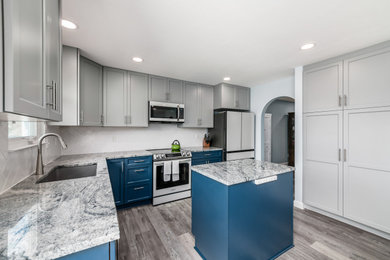 Mid-sized transitional u-shaped kitchen photo in Columbus with shaker cabinets, granite countertops, white backsplash and an island