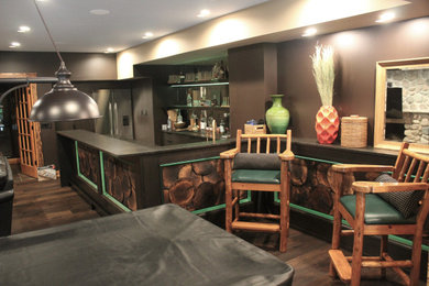 Large eclectic u-shaped dark wood floor and brown floor wet bar photo in Milwaukee with an undermount sink, flat-panel cabinets, dark wood cabinets, granite countertops, multicolored backsplash, mirror backsplash and black countertops
