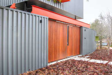 Inspiration for a mid-sized contemporary gray two-story metal flat roof remodel in Dallas