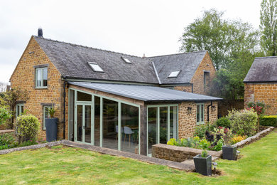 Design ideas for a rural bungalow detached house in Oxfordshire with stone cladding and a metal roof.