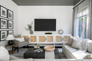 Example of a transitional shiplap ceiling living room design in Orange County with white walls and a wall-mounted tv