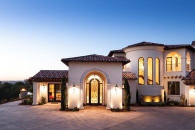 Example of a large tuscan white two-story stucco exterior home design in Sacramento