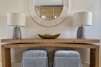 Small beach style light wood floor single front door photo in New York with beige walls