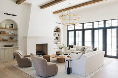 Living room - transitional medium tone wood floor, brown floor and exposed beam living room idea in Phoenix with white walls and a standard fireplace