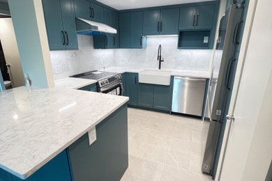 Inspiration for a small modern ceramic tile and gray floor kitchen remodel in Vancouver with a farmhouse sink, quartz countertops, quartz backsplash and stainless steel appliances