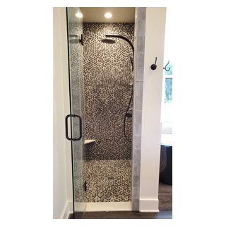Shower design done with penny rounds on the accent wall and shower ...