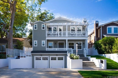 Traditional gray three-story wood house exterior idea in Los Angeles with a shingle roof