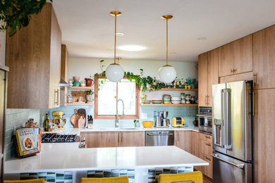 Mid-sized mid-century modern u-shaped open concept kitchen photo in Other with flat-panel cabinets, light wood cabinets, quartz countertops, blue backsplash, ceramic backsplash, stainless steel appliances, a peninsula and white countertops