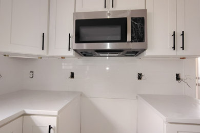 Enclosed kitchen - contemporary enclosed kitchen idea in Charlotte with white backsplash, ceramic backsplash and no island