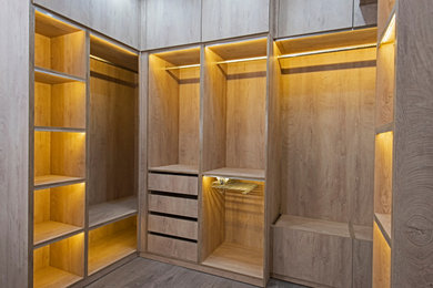 Example of a large classic gender-neutral walk-in closet design in Tampa with flat-panel cabinets
