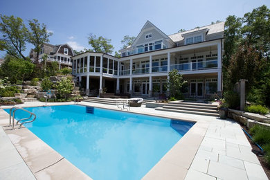 Inspiration for an expansive modern rectangular pool in Chicago with natural stone pavers.