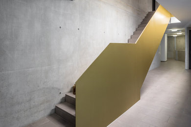 This is an example of a large industrial concrete straight staircase in Stuttgart with concrete risers and metal railing.