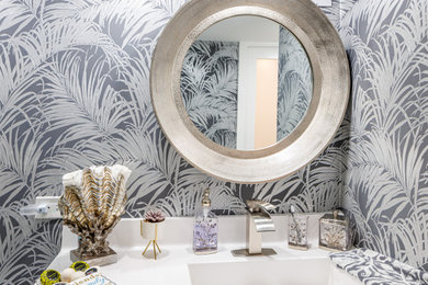 Example of a small minimalist gray tile and porcelain tile porcelain tile, white floor, single-sink, vaulted ceiling and wallpaper shower bench design in Miami with shaker cabinets, white cabinets, a one-piece toilet, gray walls, an integrated sink, quartz countertops, a hinged shower door, white countertops and a built-in vanity
