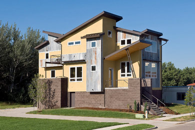 Inspiration for a mid-sized industrial yellow three-story exterior home remodel in Denver