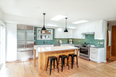 Example of a transitional l-shaped kitchen design in Detroit with an island