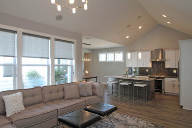Living room - mid-sized contemporary formal and open concept laminate floor living room idea in Cedar Rapids with gray walls, a standard fireplace and a stone fireplace