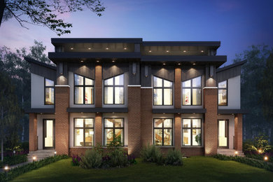 Large modern red three-story brick exterior home idea in Calgary