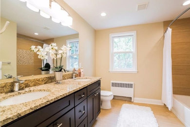 Inspiration for a mid-sized timeless master ceramic tile and beige floor bathroom remodel in Philadelphia with shaker cabinets, dark wood cabinets, brown walls, an undermount sink and granite countertops