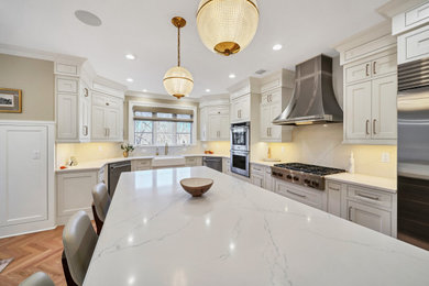 Example of a medium tone wood floor open concept kitchen design in New York with a farmhouse sink, recessed-panel cabinets, white cabinets, quartz countertops, white backsplash, quartz backsplash, stainless steel appliances, an island and white countertops