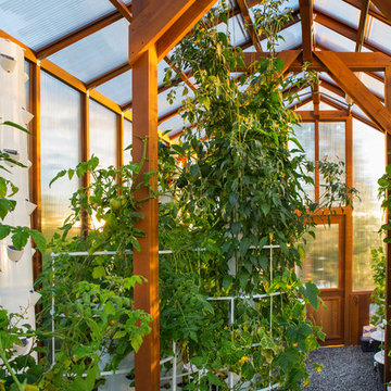 Contemporary deck with custom rails, decking, gate and greenhouse