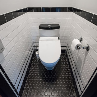 Bathroom - large transitional master black and white tile and ceramic tile porcelain floor and black floor bathroom idea in Providence with open cabinets, a two-piece toilet, gray walls, a console sink, a hinged shower door and black countertops