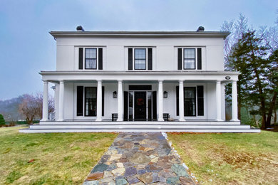 Inspiration for a huge timeless white two-story exterior home remodel in Boston