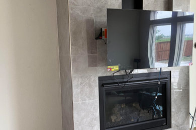 Inspiration for a living room remodel in Dallas with a tile fireplace