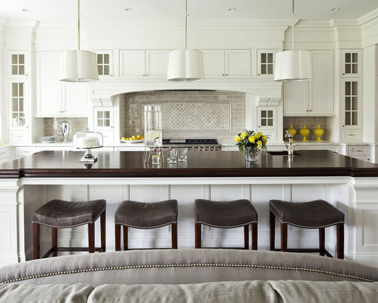 Large transitional open concept kitchen inspiration - Large transitional l-shaped painted wood floor open concept kitchen photo in Minneapolis with wood countertops, recessed-panel cabinets, white cabinets, gray backsplash, an undermount sink, ceramic backsplash, stainless steel appliances and an island