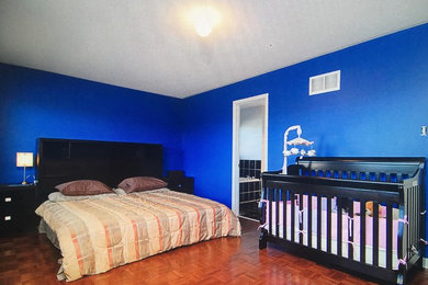 Bedroom - large mediterranean master bedroom idea in Toronto with blue walls