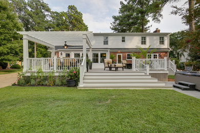 Inspiration for a modern backyard deck remodel in Other with a pergola