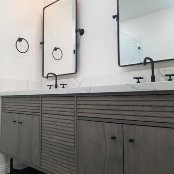 Beautiful, sleek, curb-less white and black shower and tub bathroom