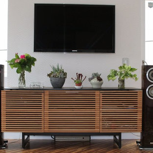 Design ideas for a medium sized contemporary open plan home cinema in Other with white walls, bamboo flooring and a wall mounted tv.