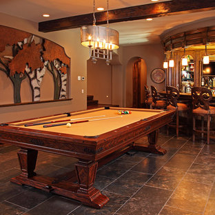 ミネアポリスの大きいラスティックスタイルのおしゃれな着席型バー (フラットパネル扉のキャビネット、濃色木目調キャビネット、木材カウンター、セラミックタイルの床) の写真