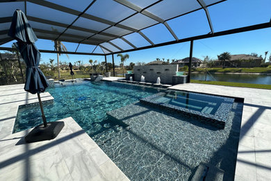 Inspiration for a huge contemporary backyard stone and custom-shaped natural pool house remodel in Other
