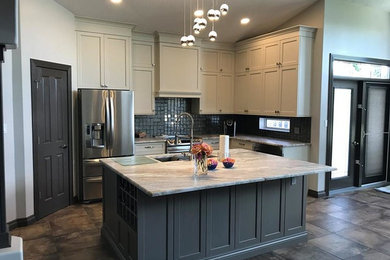 Elegant l-shaped kitchen photo in Edmonton with an island