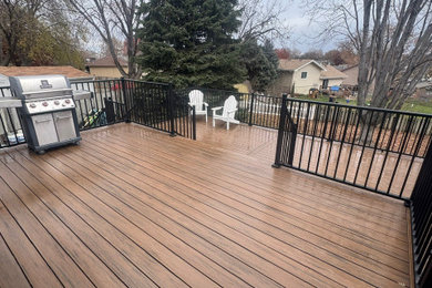Deck - large metal railing deck idea in Omaha with no cover