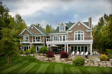 Inspiration for a timeless brown two-story concrete fiberboard gable roof remodel in Other