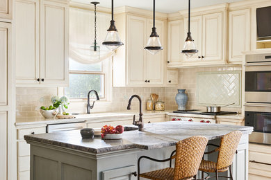 Inspiration for a traditional kitchen in Dallas with an undermount sink, raised-panel cabinets, marble benchtops, ceramic splashback, stainless steel appliances, dark hardwood floors and with island.