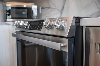 Example of a large minimalist kitchen design in New York with stainless steel appliances