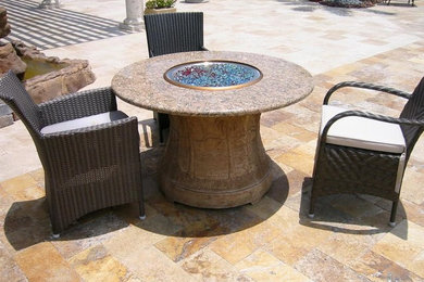 Inspiration for a mid-sized modern side yard stone patio remodel in Miami with a fire pit and no cover