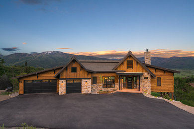 Inspiration for a mid-sized rustic brown two-story wood exterior home remodel in Denver with a metal roof