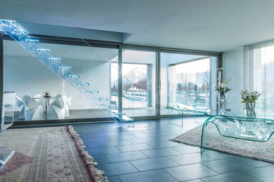 Mid-sized minimalist glass straight open staircase photo in Other