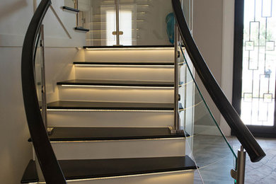 Mid-sized trendy wooden floating mixed material railing staircase photo in Other with painted risers