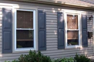 Inspiration for a large traditional white exterior in Chicago with wood siding.
