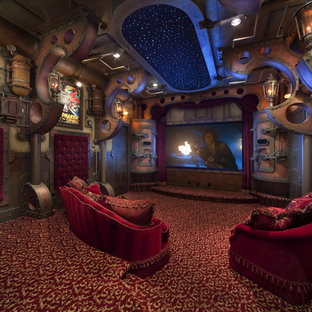 Large urban enclosed carpeted and multicolored floor home theater photo in Orlando with a projector screen