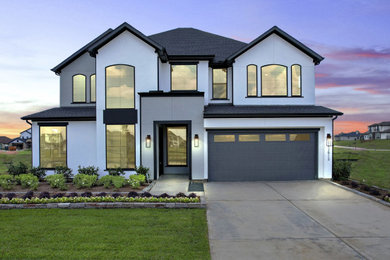 Example of a large minimalist two-story house exterior design in Houston with a shingle roof and a gray roof