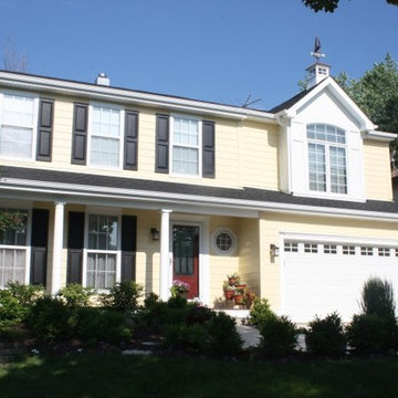 Cape Cod Style: Yellow Siding, White Trim, Black Shutters, Red Door, Roof Cupola