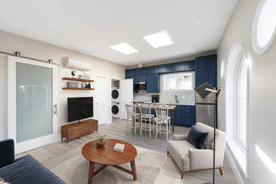 Small trendy vinyl floor and gray floor living room photo in DC Metro with white walls, no fireplace and a tv stand